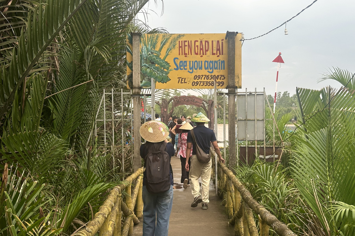 Travelers boarding a vehicle between stops on a Ho Chi Minh City day tour