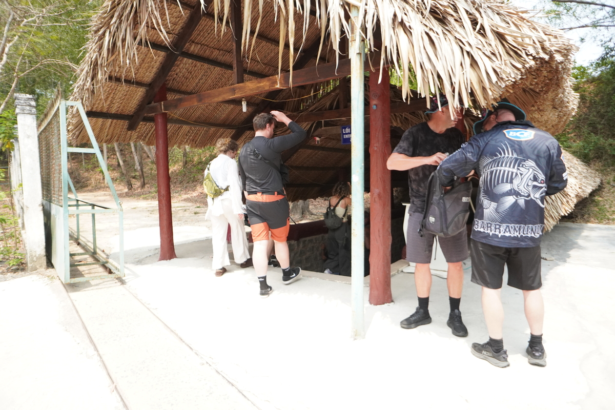 Visitors inside an underground bunker at the Cu Chi Tunnels on a full day tour with the city