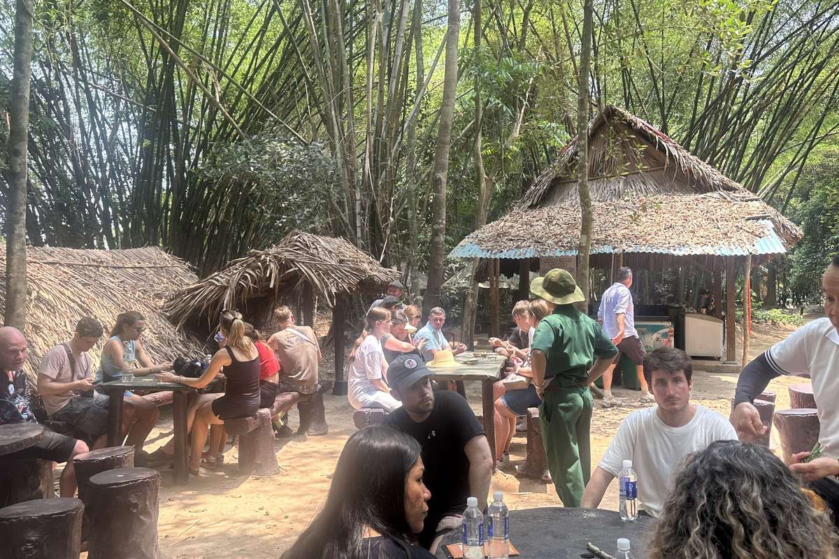 Morning vs full day Cu Chi tour: guests taking a tea and cassava break in the forest