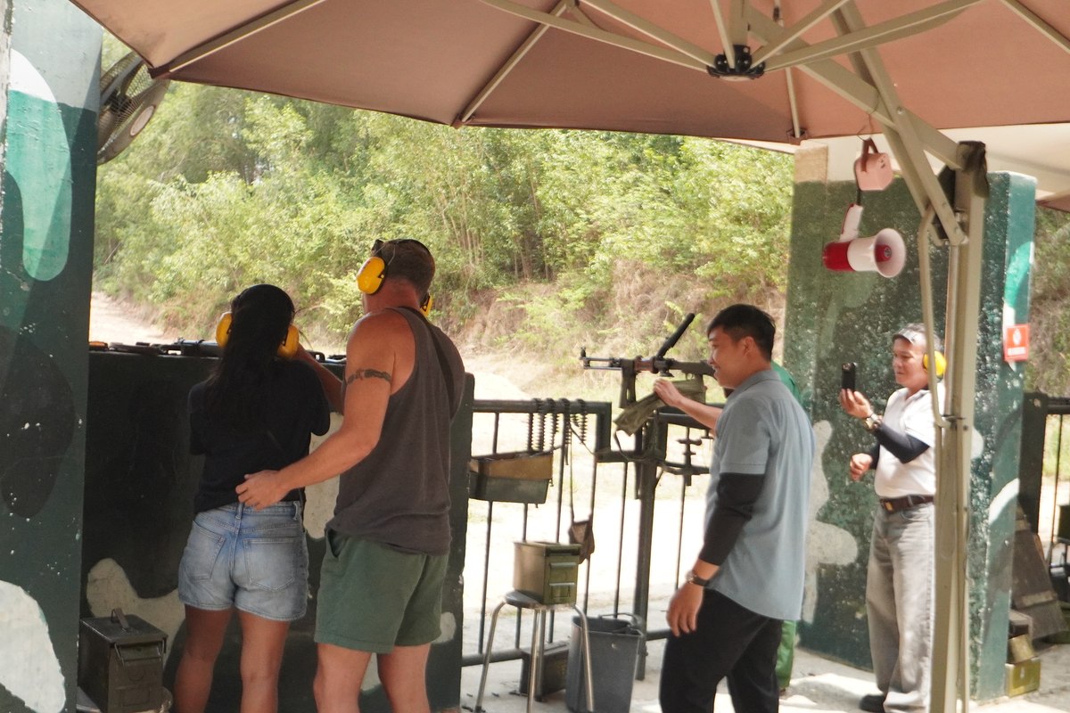 Cu Chi tunnel Ben Dinh: visitors with ear protection at the shooting range